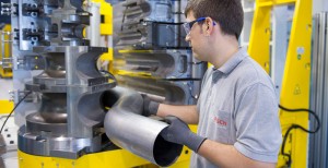 Assembly line  of Bosch Emission Systems Bosch Emission Systems benefits from its  state-of-the-art production line.  The picture shows the forming of pipes with a diameter between 2.5  and 6 inches on  a fully electronic controlled machine.