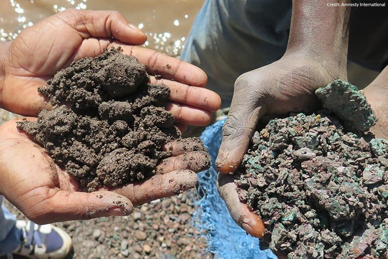 Hands holding cobalt mined in the DRC