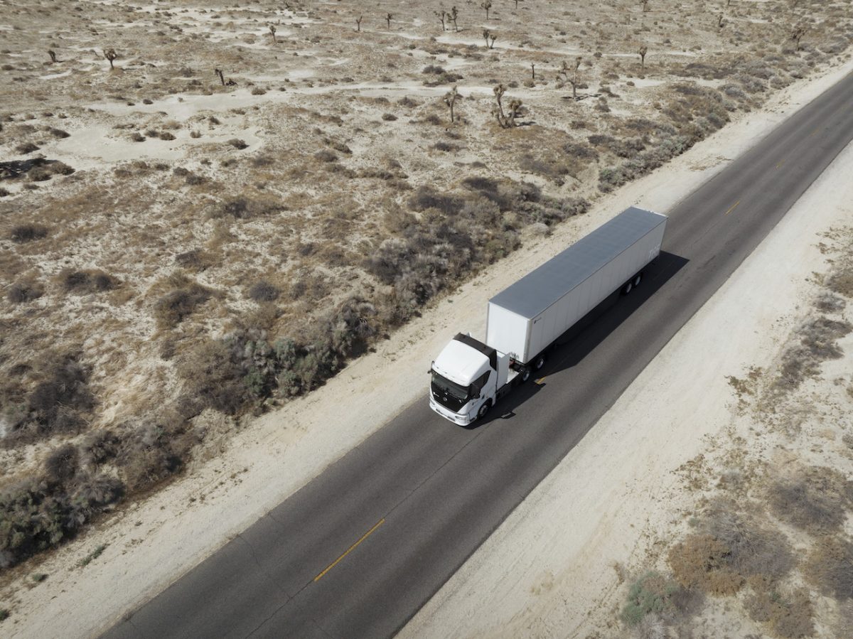A truck driving on a desert road