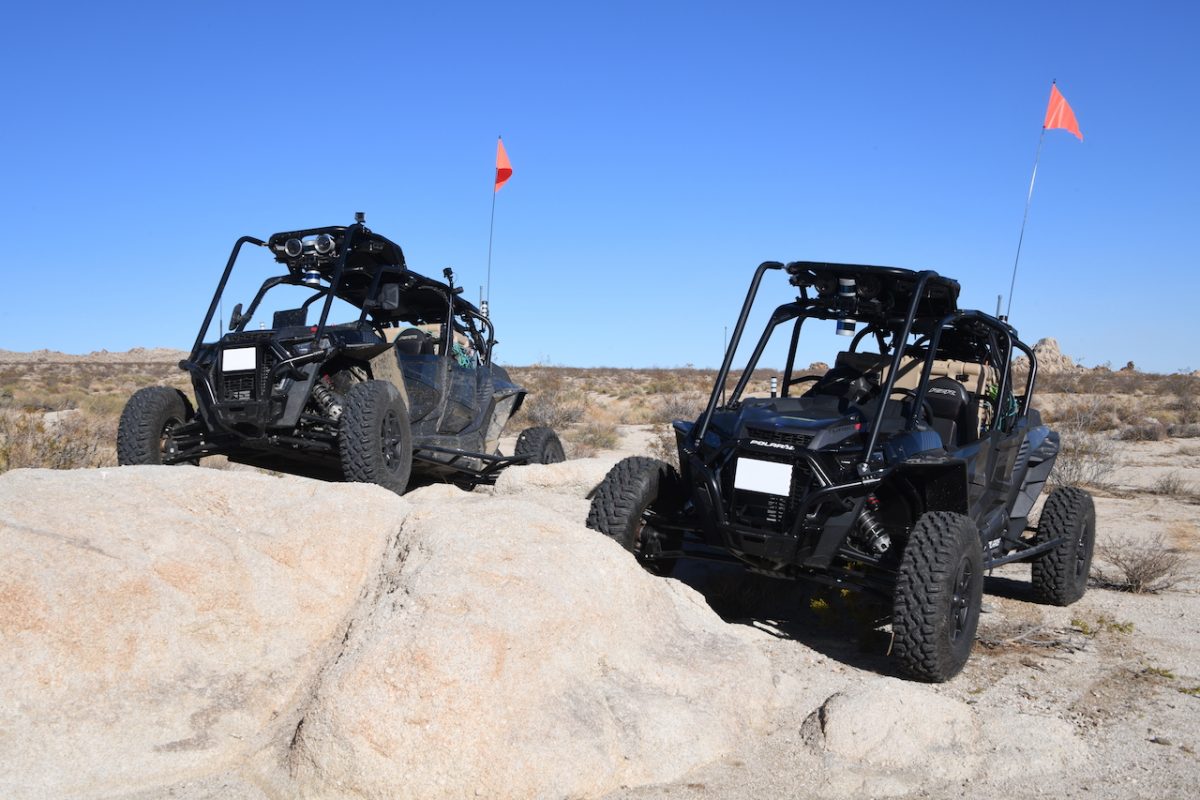 Two vehicles parked in rocky terrain